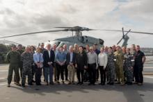 Group photo standing in fron tof SeaKing helicopter